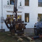 Planer being off loaded in front of Centennial Hall readying for its move inside